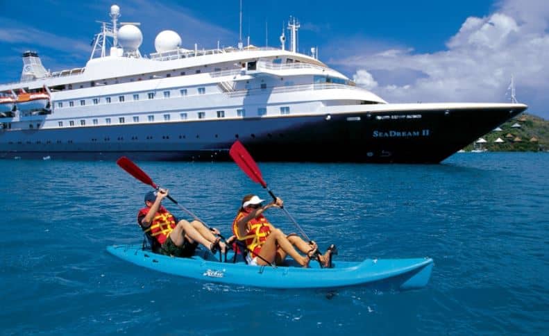 Getting a patent can free up time to do things you love Photo is couple kayaking along near luxury cruise liner 
