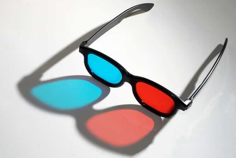 3D glasses casting a colorful shadow on the table