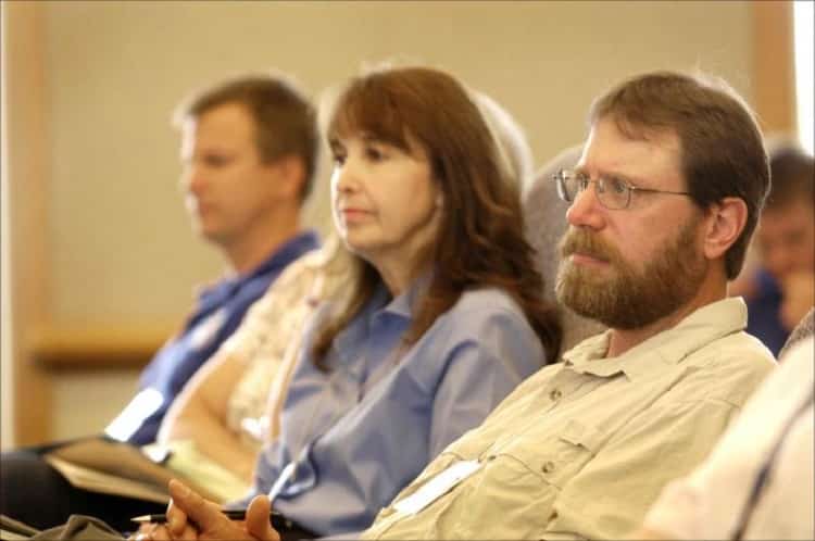 Three people listening during a meeting