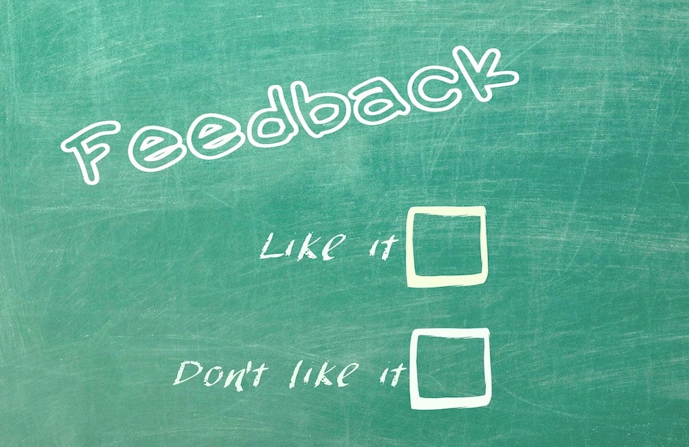 A chalkboard with "feedback" writing across it and two boxes to check. Someone leaving a product review will mark the box for "like it" or "don't like it."